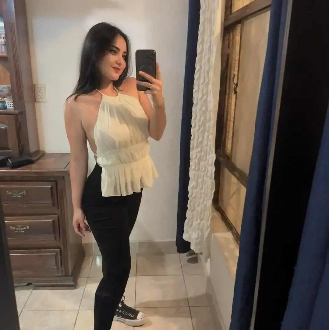 Aysha Pakistani escort profile with a Downtown Dubai city view