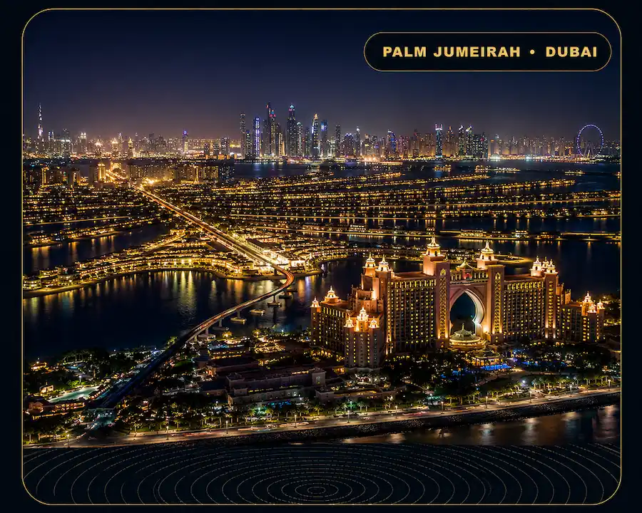 Palm Jumeirah Escorts aerial island view with Atlantis resort, Dubai skyline and illuminated waterfront