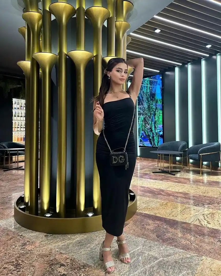 Suman Indian escort profile beside a modern City Walk art wall